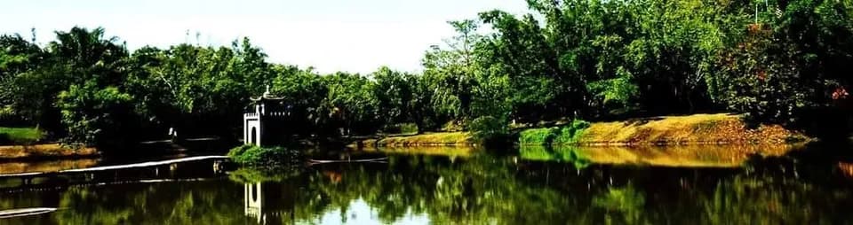 Toàn cảnh hồ với miếu nhỏ và cây xanh soi bóng